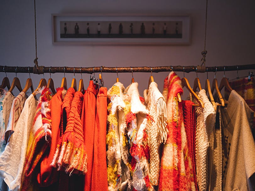 Clothes rail with colourful garments hanging from it