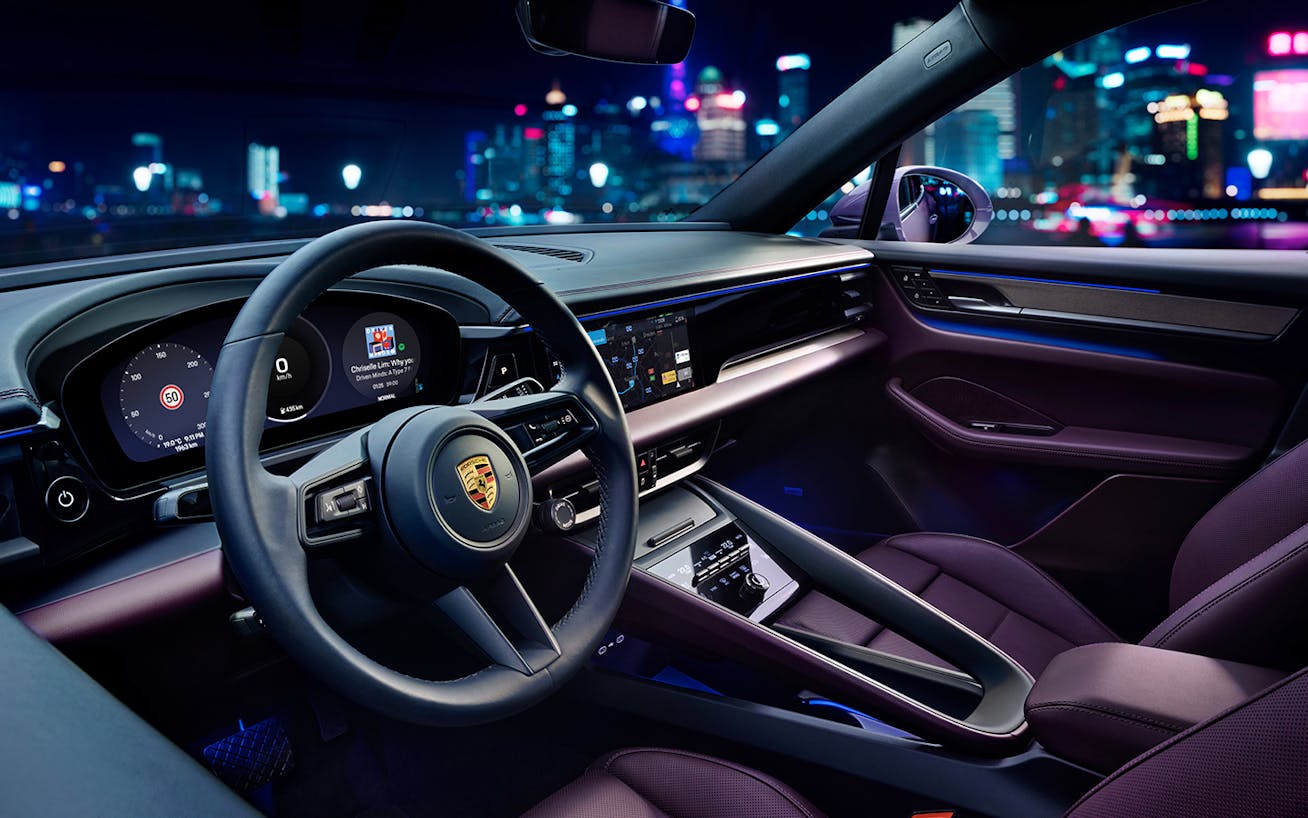 Interior of Porsche Macan 4 Electric, cityscape behind