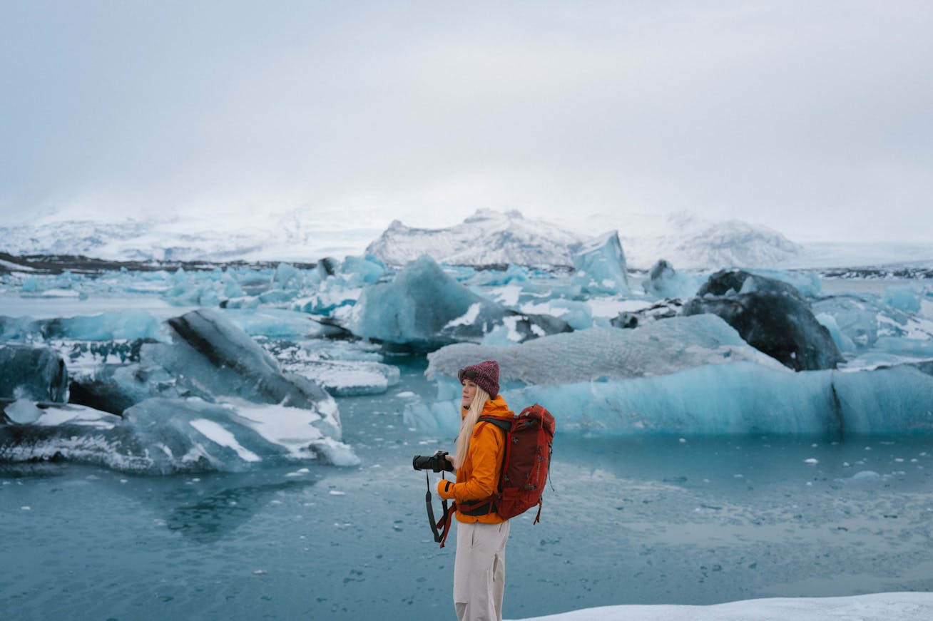 Woman with camera at Jökulsárlón glacial lagoon