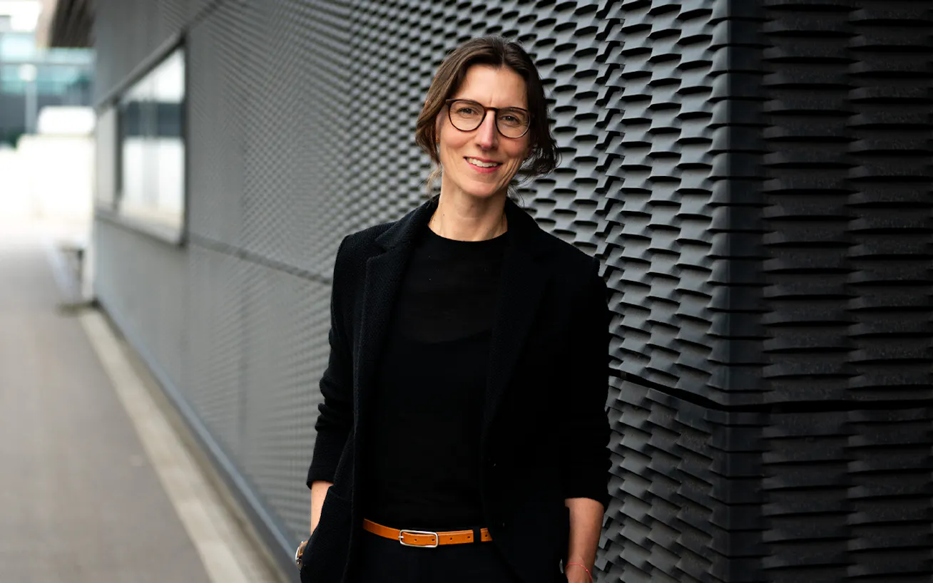 Porsche Patricia Bernstein standing against black wall Shaping Porsche series