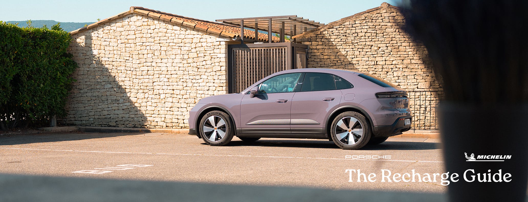 Porsche Macan Electric 4, traditional Provençal buildings behind