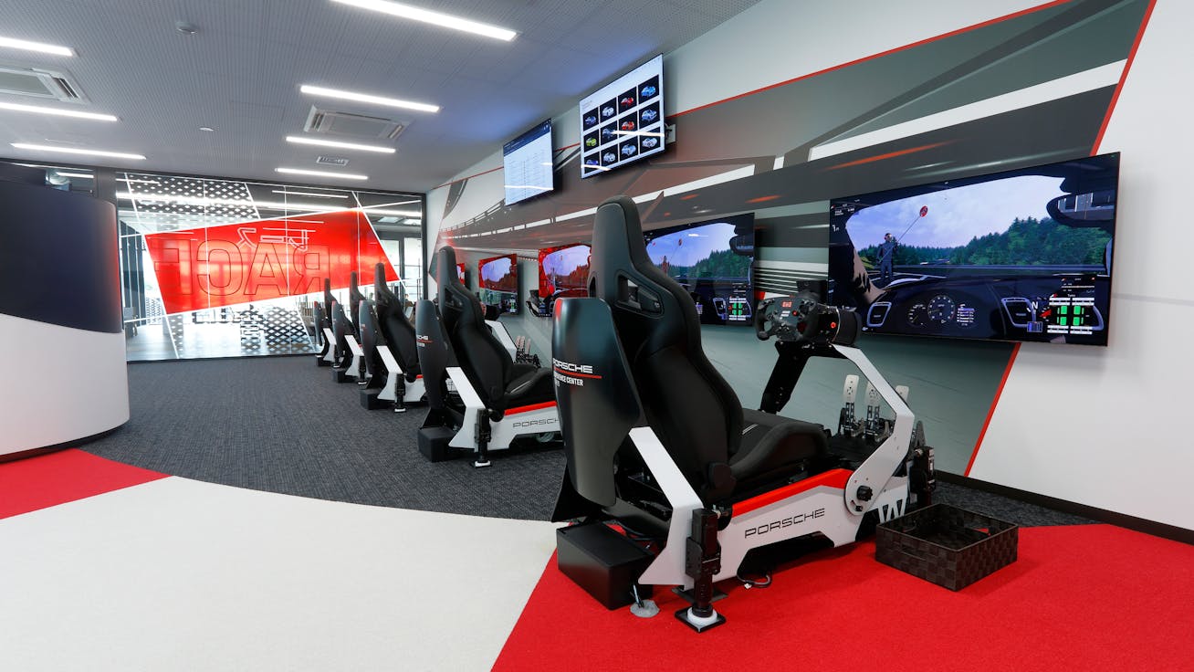 Racing sim chairs and screen at Porsche Experience Center Tokyo