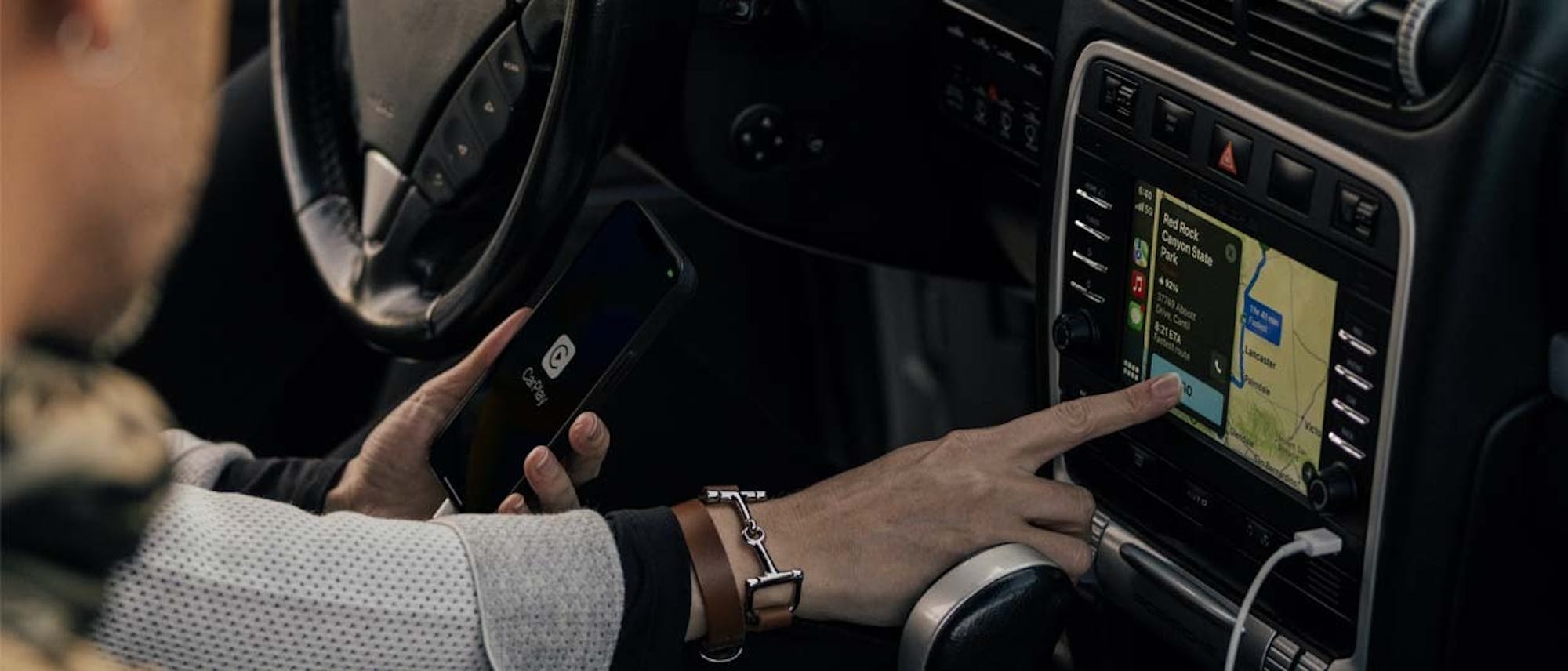 Person touching Porsche Cayenne PCCM touchscreen