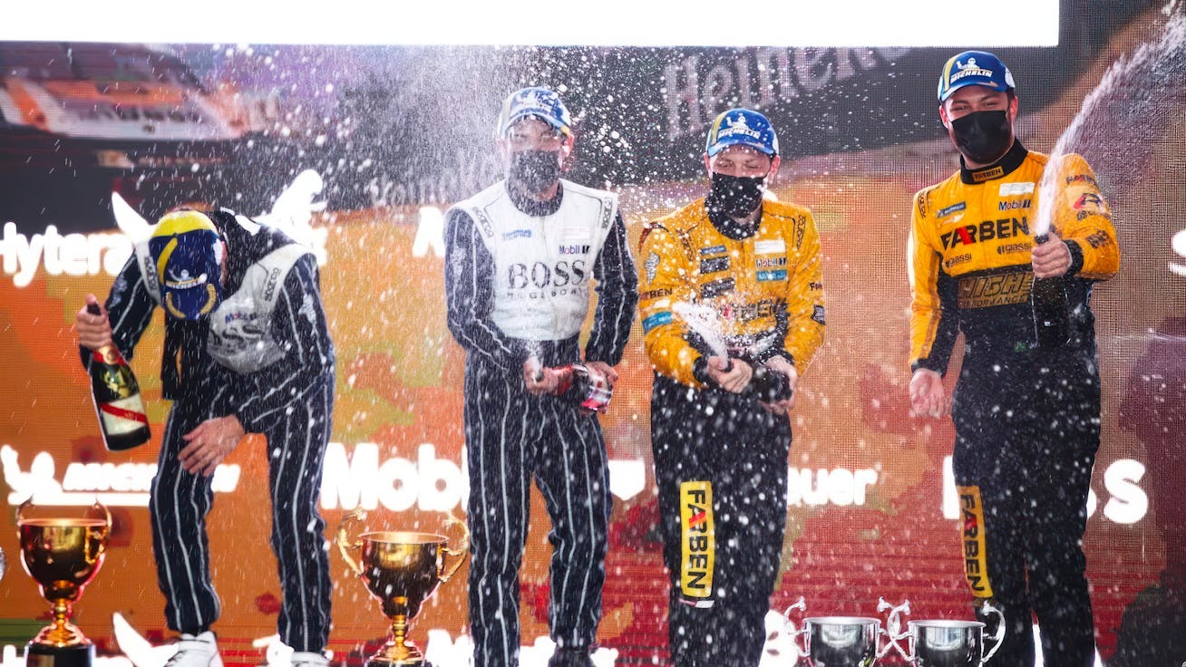 Porsche Cup Brasil drivers celebrate on podium with champagne