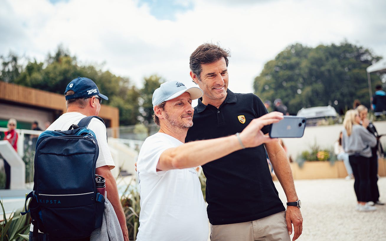 Mark Webber taking a photo with a fan