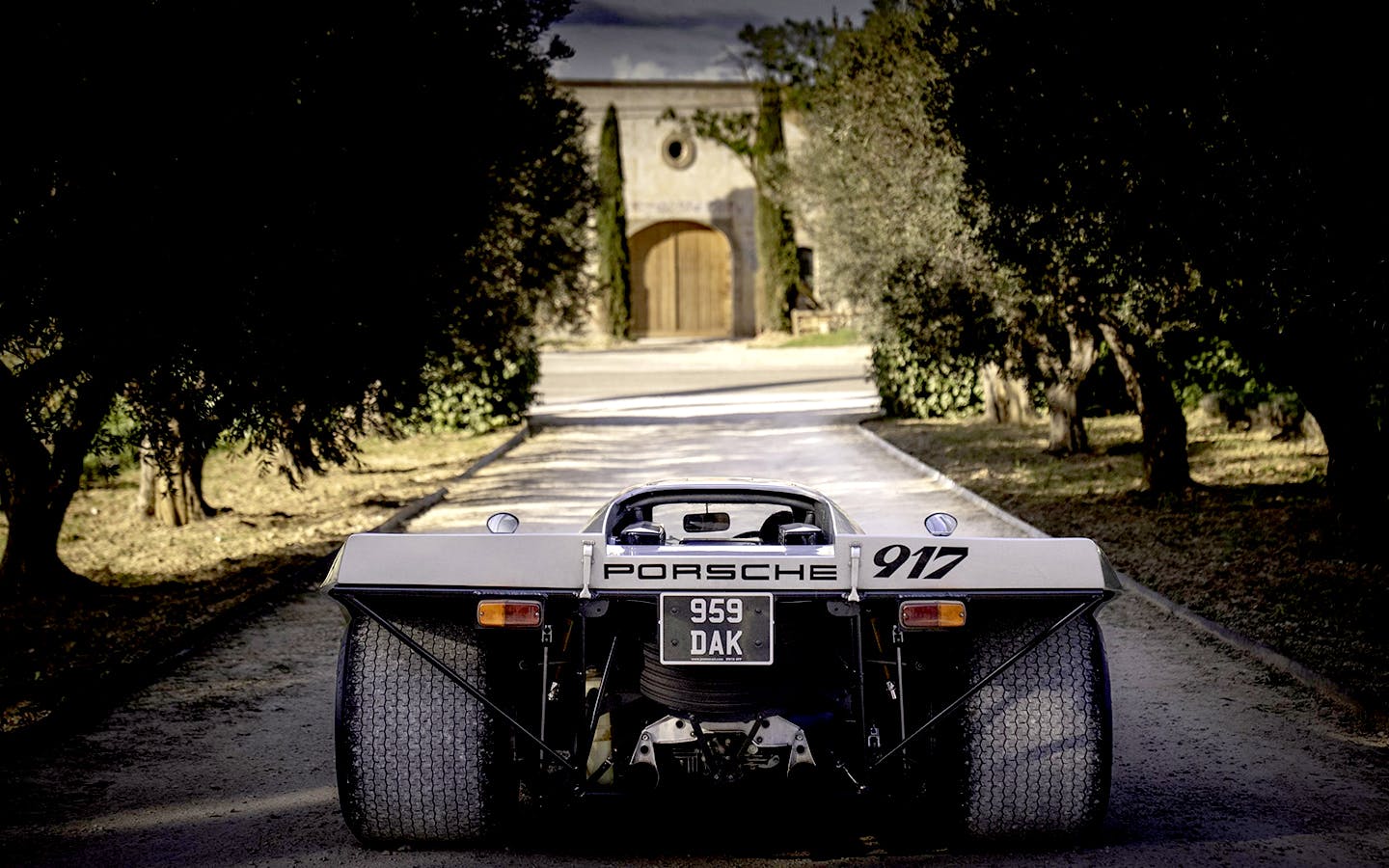 Rear of Porsche 917 KH Street looking down tree-lined avenue