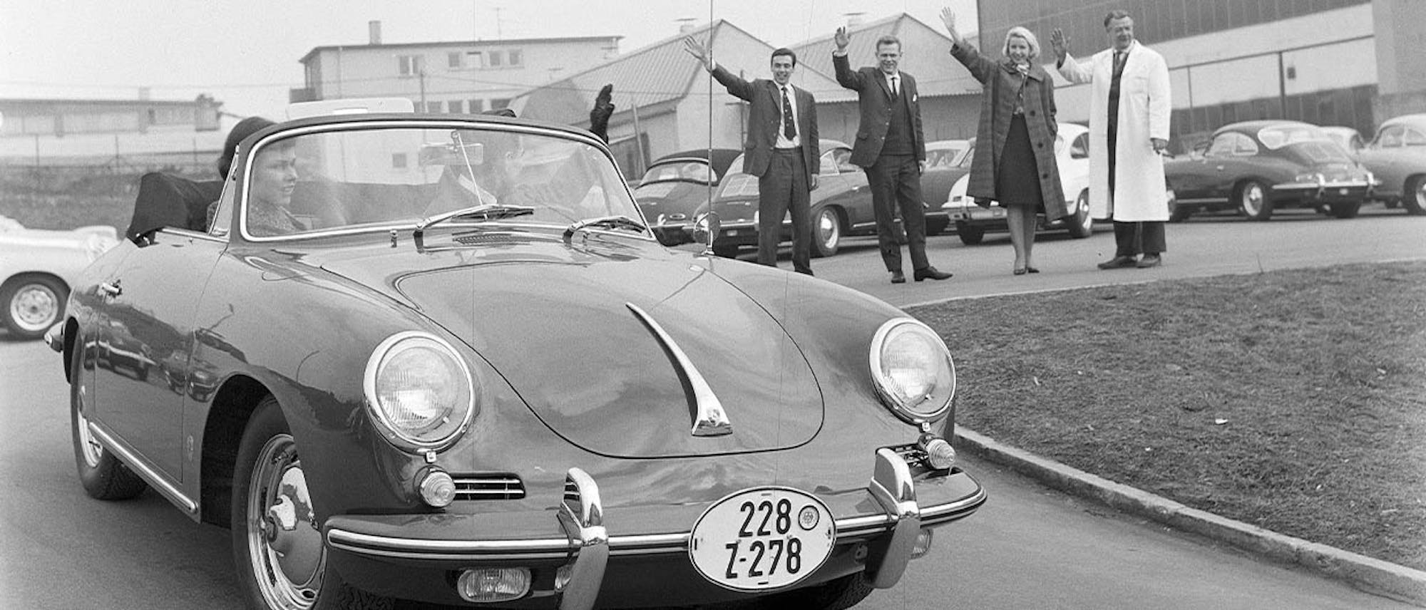 Black and white photo of Porsche leaving factory in early 1960s