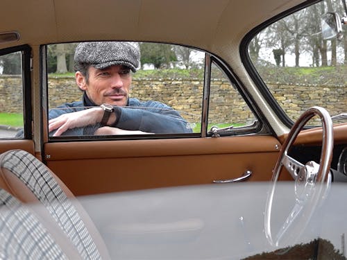 David Gandy peers through open window into car