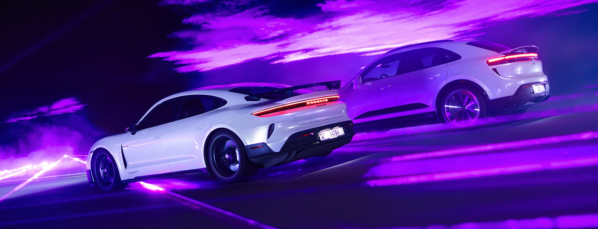 Porsche Taycan Turbo with Weissach package and Macan Turbo Electric lit by lasers