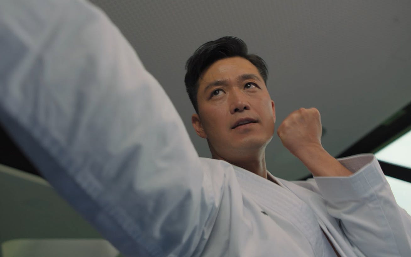 Man wearing a karate gi performing a karate move