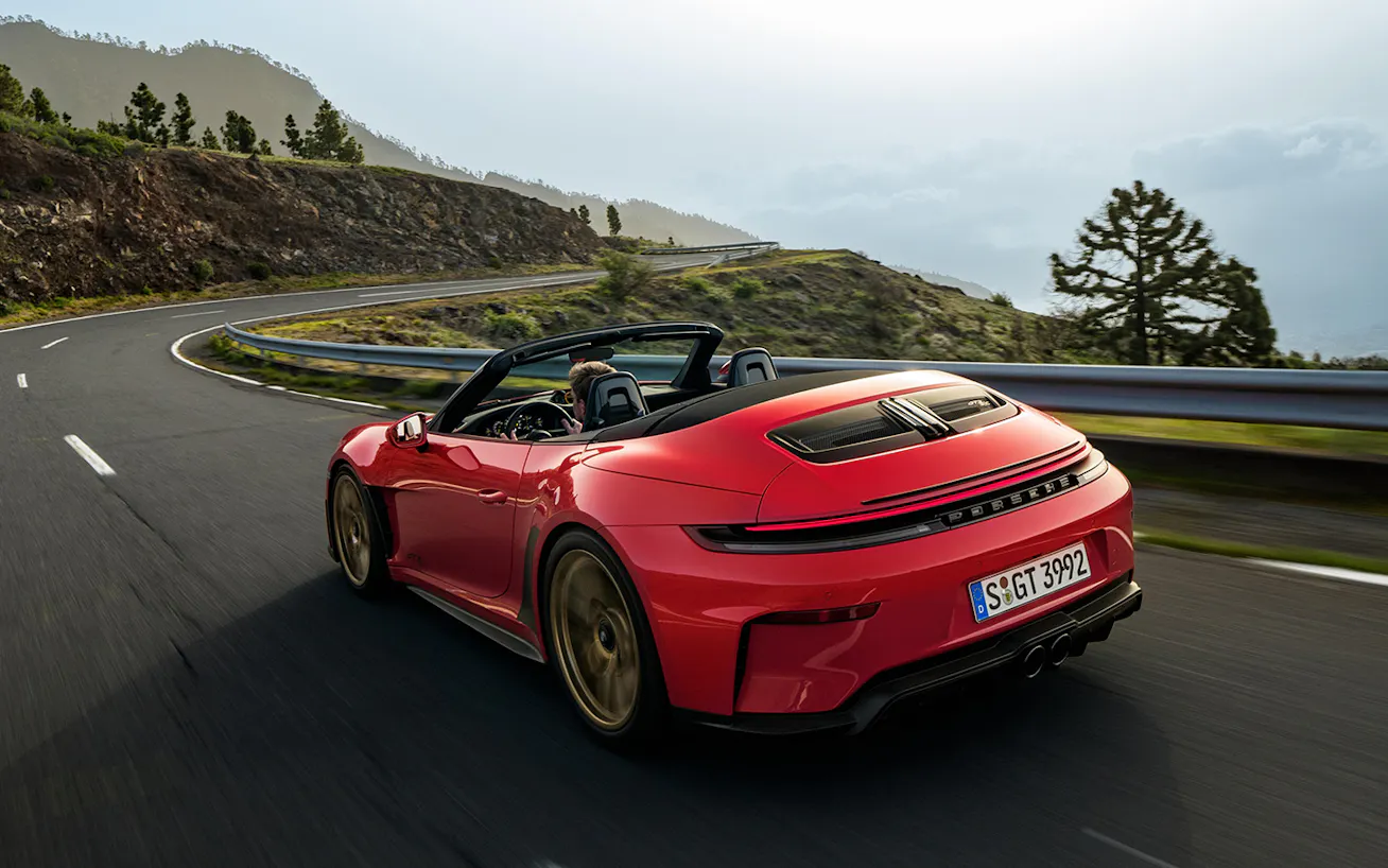 Rear view of Porsche 911 GT3 S:C in Guards Red driving on hilly road