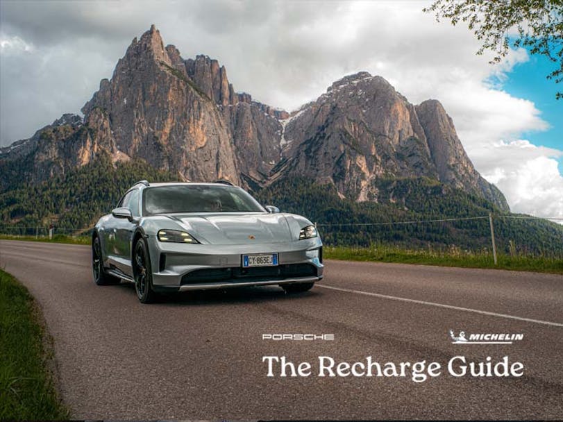 Porsche Taycan Cross Turismo driving on road, mountains in background