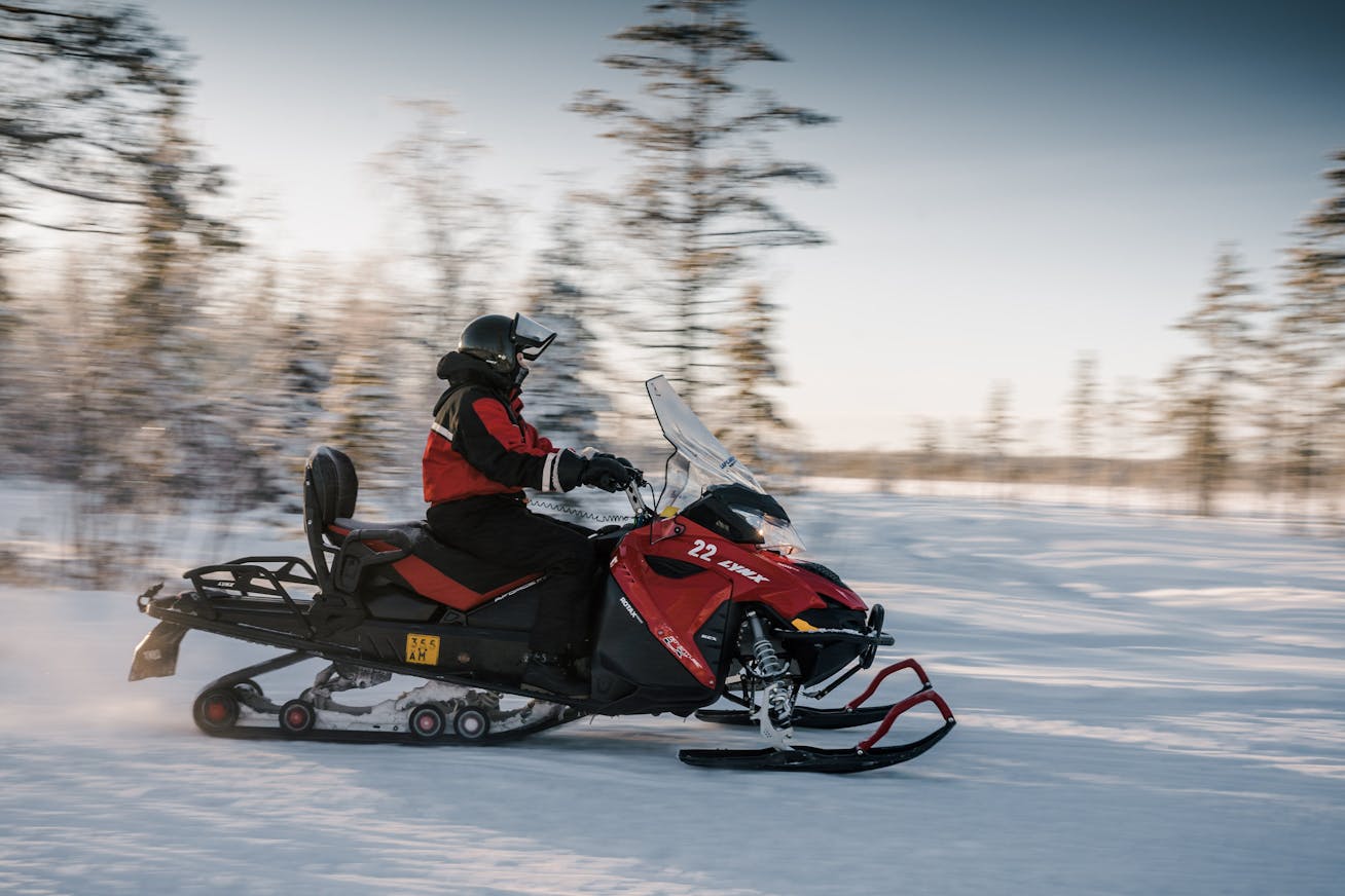 A man rides a snowmobile on the Porsche Ice Experience accompanying programme in Levi, Finland
