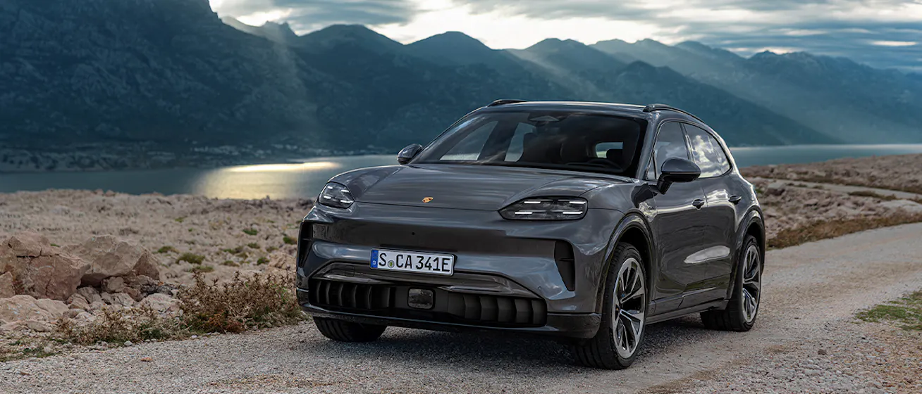 Porsche Turbo Electric parked beside mountain lake_conversion desktop