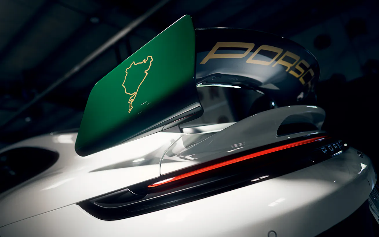 View of rear aero on Porsche 911 GT3 100 Jahre Nürburgring featuring a depiction of the layout of the Nürburgring circuit
