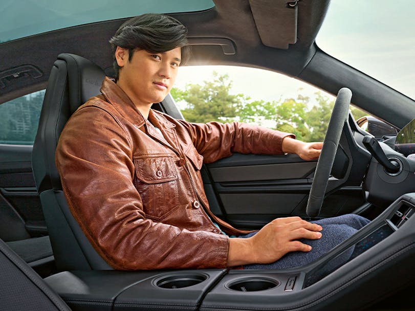 Baseball player Shohei Ohtani sat in a Porsche Taycan