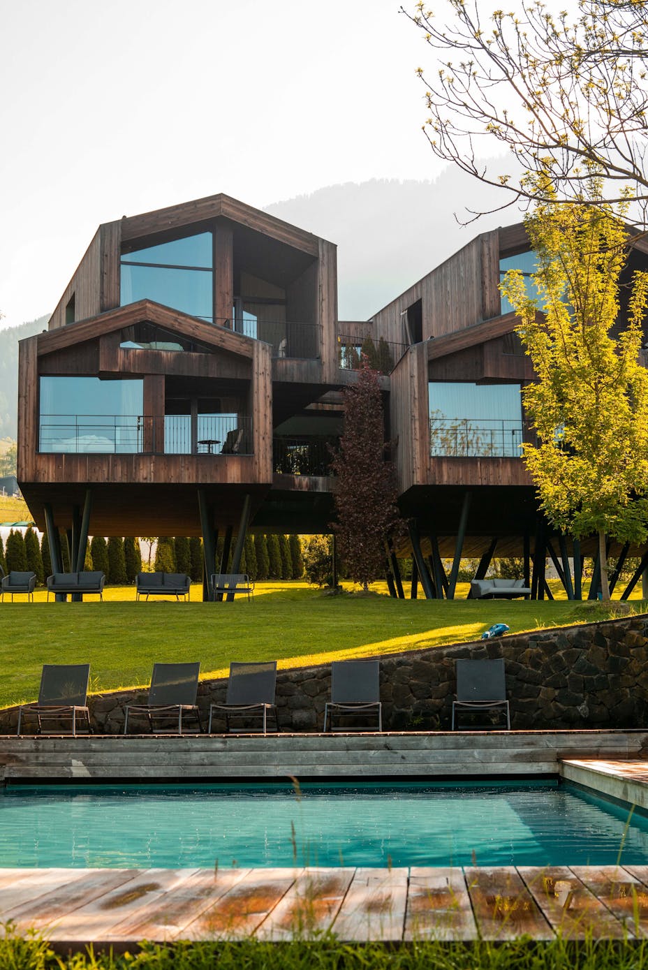 Modern hotel building in the Dolomites with mountains behind