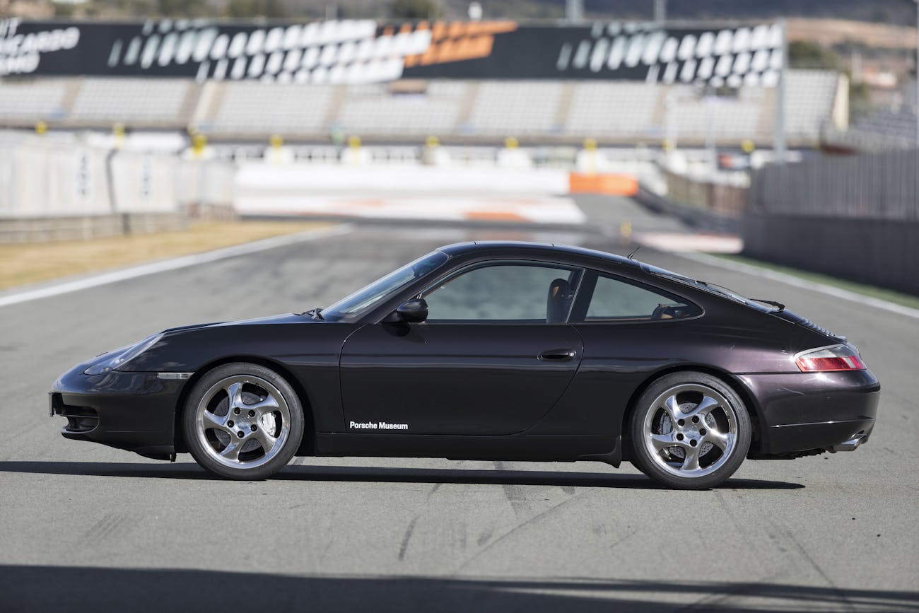 Side view of black Porsche 911 (996) parked on racetrack