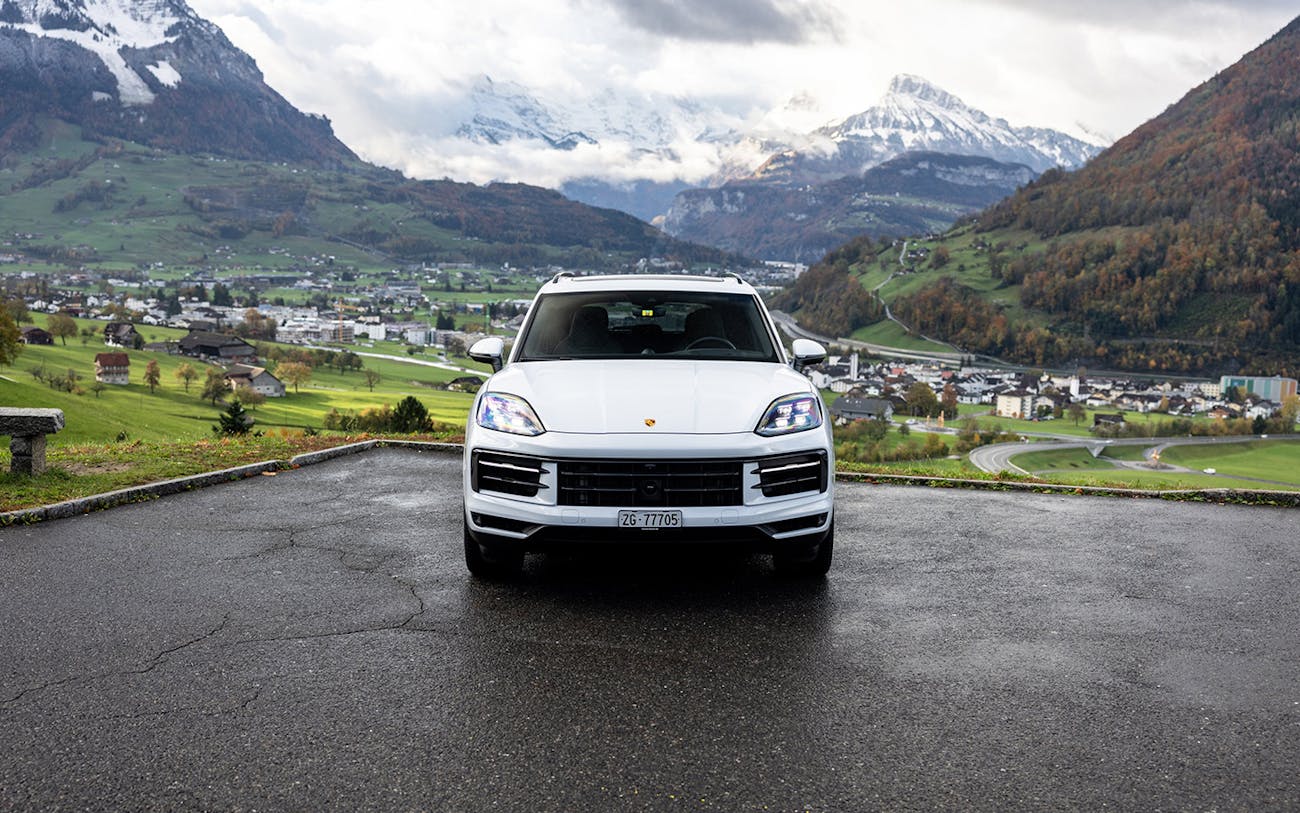 Front view of white Porsche Cayenne E-Hybrid in Alpine setting