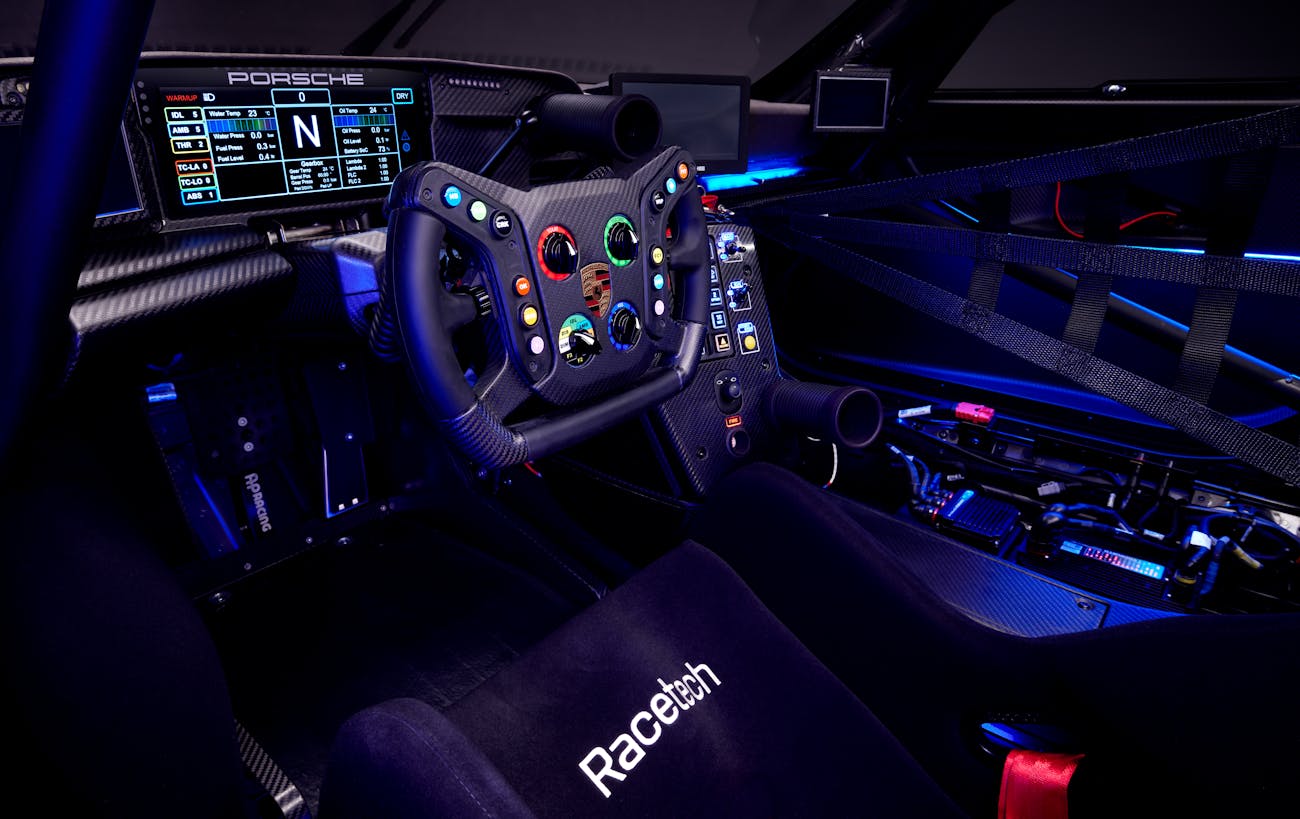 Porsche GT3 R rennsport interior, featuring dashboard and RaceTech seat