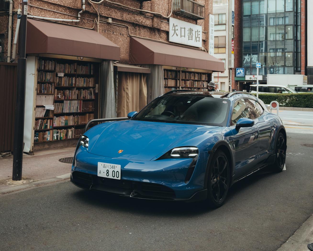 Porsche Taycan Turbo Cross Turismo in front of Tokyo bookshop