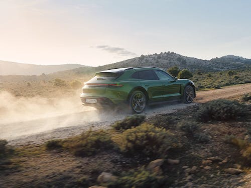 Green Porsche Taycan Cross Turismo on dusty road