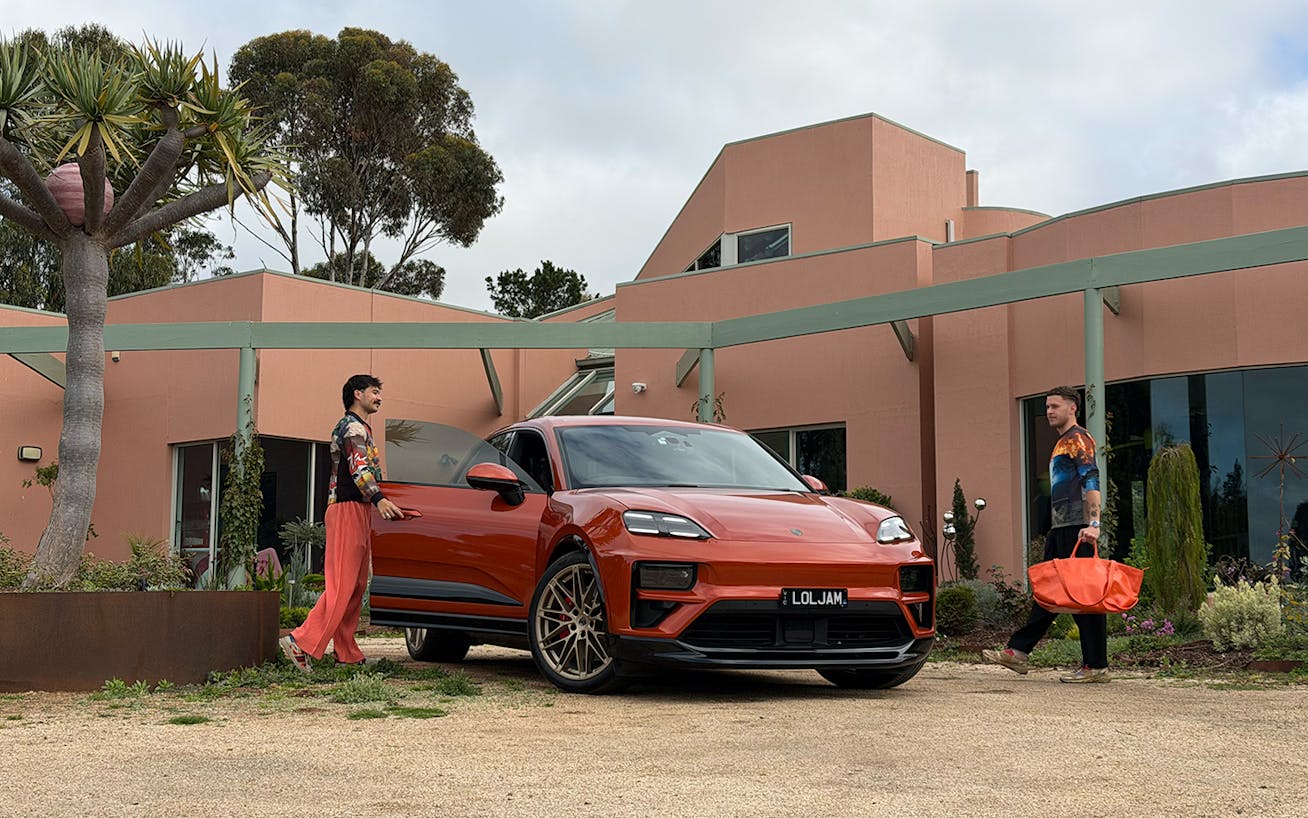 Two men with Porsche Macan Turbo Electric outside house in Melbourne, Australia