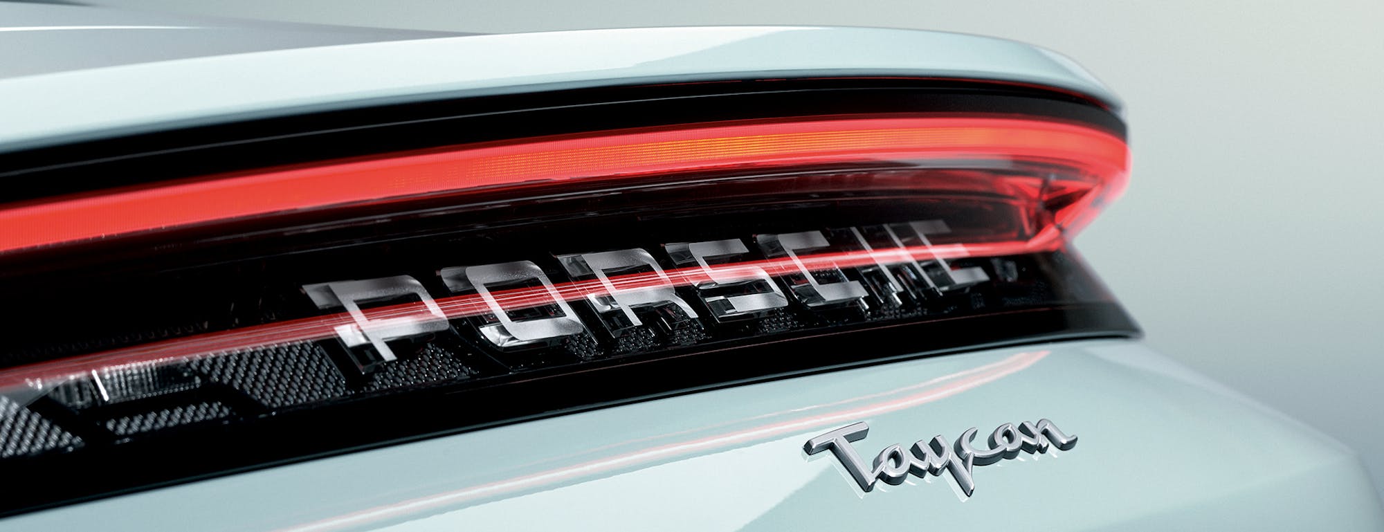 Porsche Taycan script nameplate on rear of car