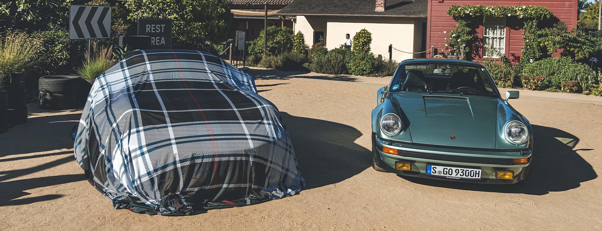 Porsche 930 Turbo with covered car at Monterey Car Week 