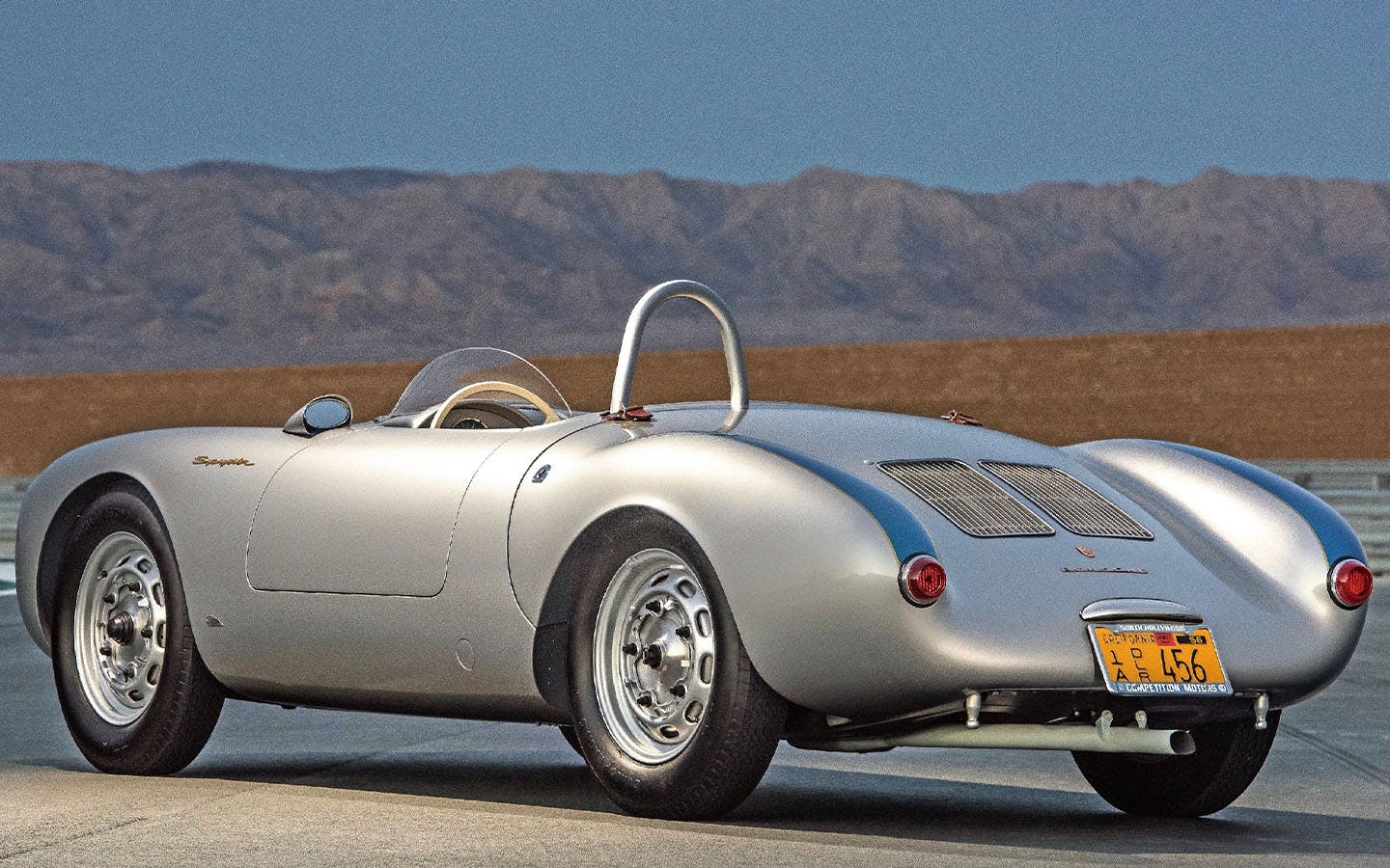 Porsche 550 Spyder on track, hills in background