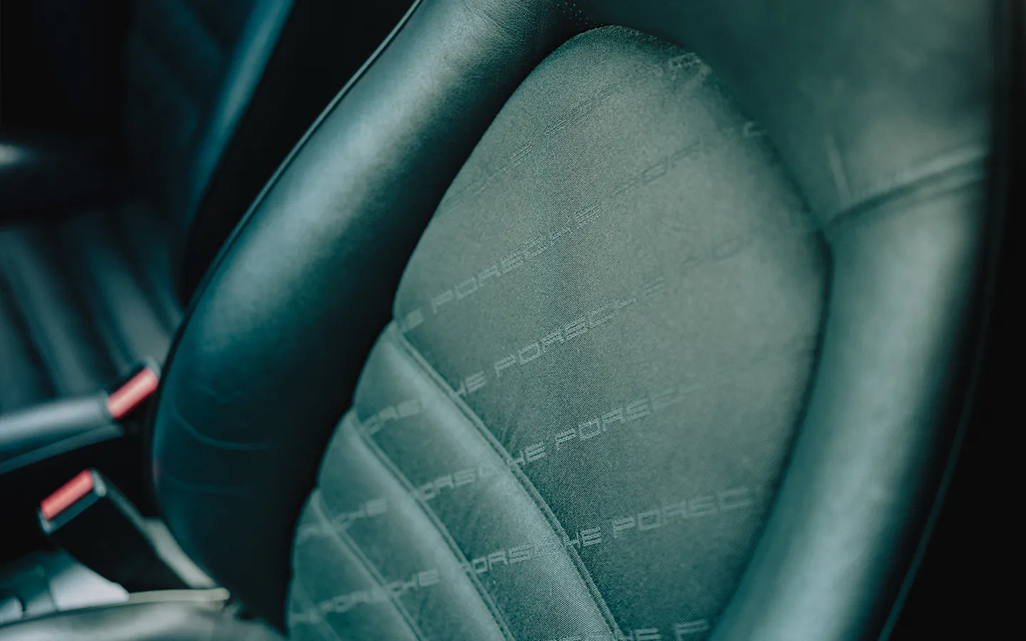 Original Porsche leather on seat of black Porsche 911 Carrera S/C