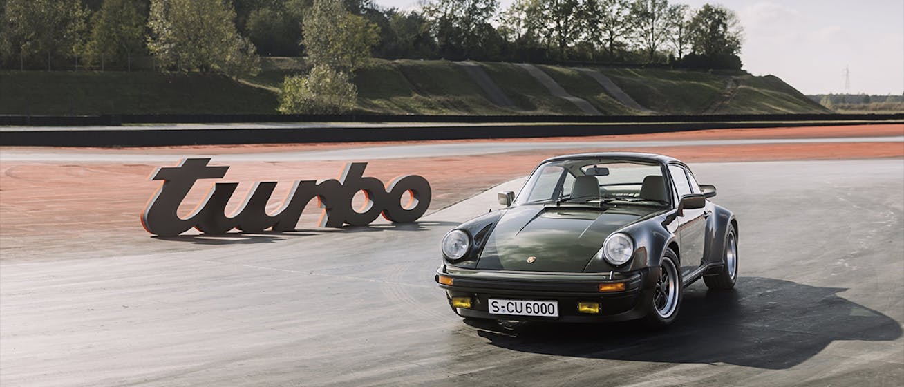 Porsche 911 Turbo (type 930) next to Turbo sign