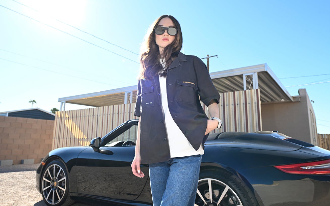 Woman in sunglasses in front of Porsche 911 Carrera Cabriolet