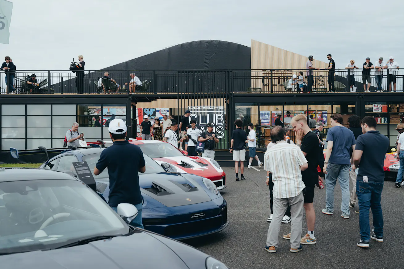 Crowds gathering around Porsche cars outside the Clubhaus at Sunstede