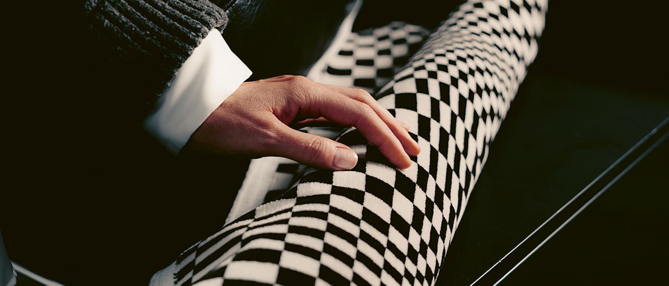 Woman stroking piece of Historical Fabrics by Porsche Pasha cloth conversion desktop