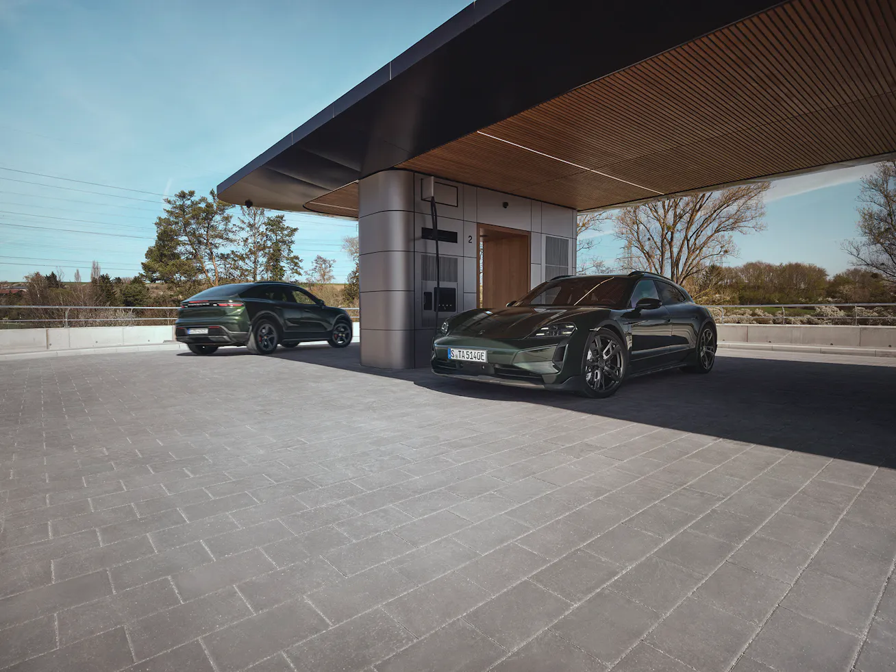 Porsche Cayenne Coupe and Porsche Taycan parked at electric charging station