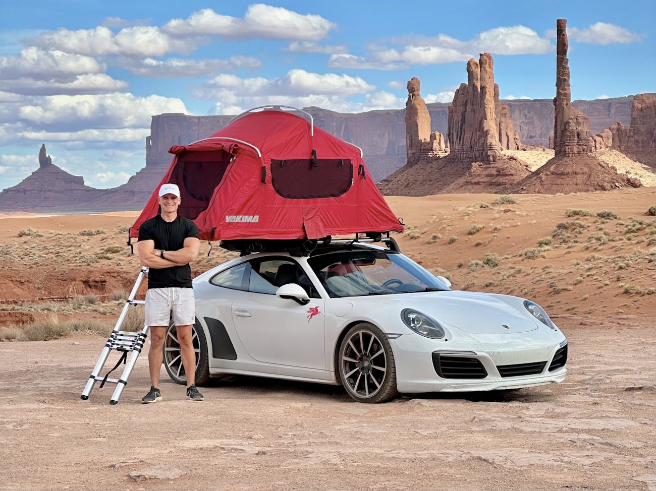 Man and Porsche 911 Carrera 4 in Monument Valley, USA
