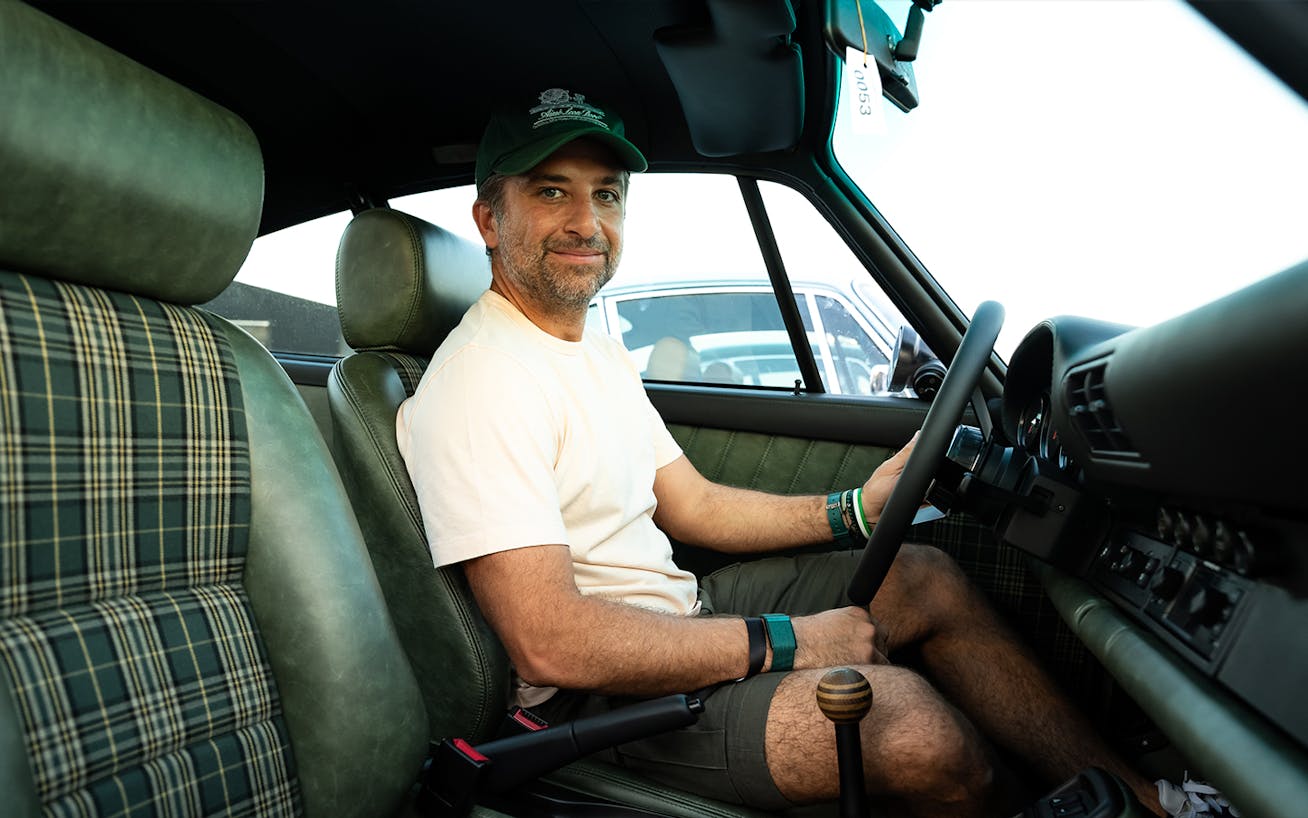 Chef Sultan Chatila from Eleven Green burgers, sitting inside restored Porsche 964 at the 2025 Icons of Porsche, Dubai 