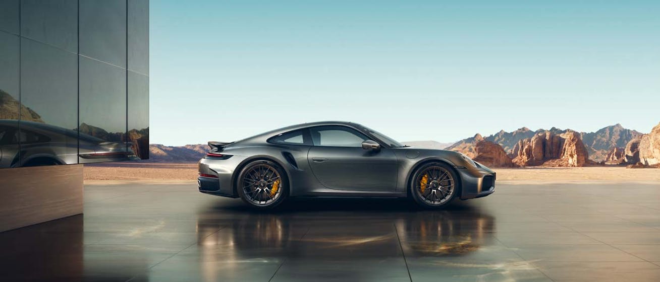 Porsche 911 Turbo S (type 992.2) parked side on with mountains in background