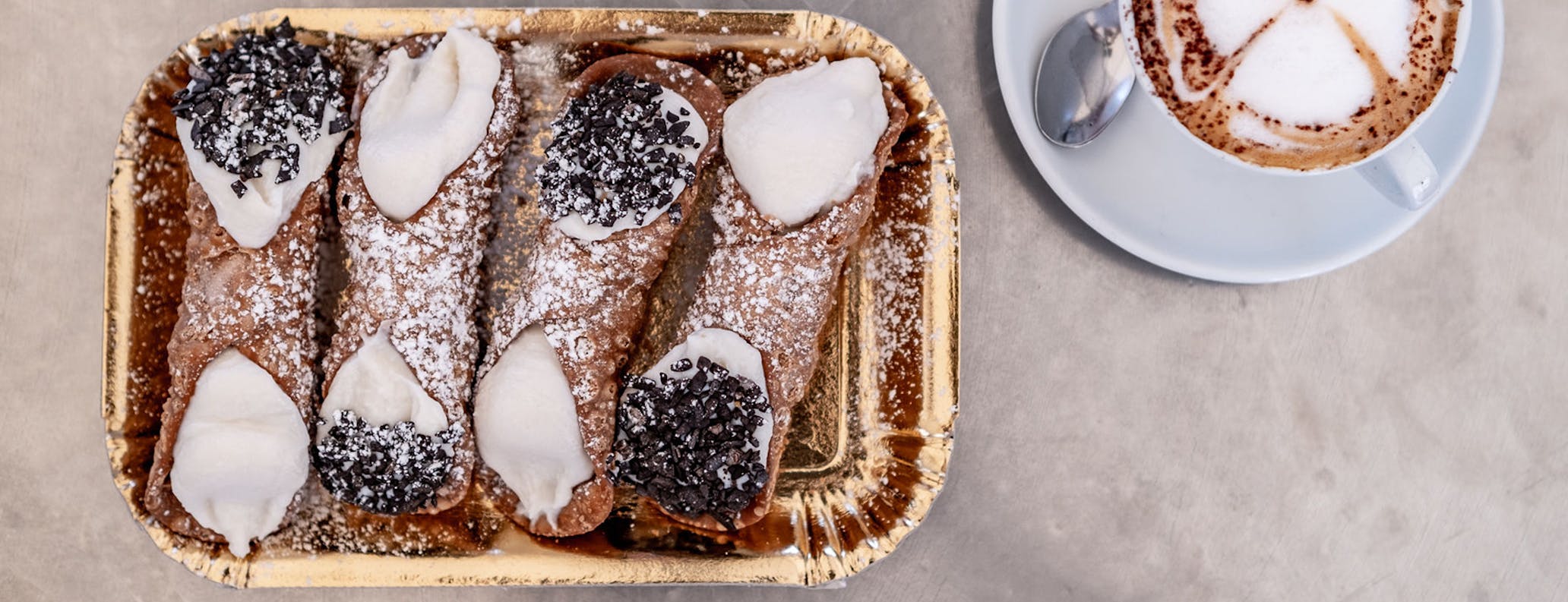 Plate of Sicilian cannoli and coffee served up for participants of the Porsche Travel Experience Sicily