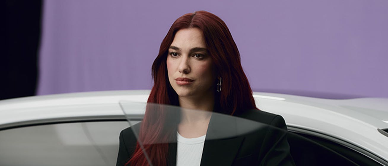 Dua Lipa exits a white Porsche Macan Electric