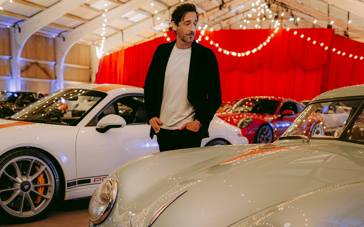 Adrien Brody walks among cars at Porsche Autokino at 2025 Goodwood Festival of Speed