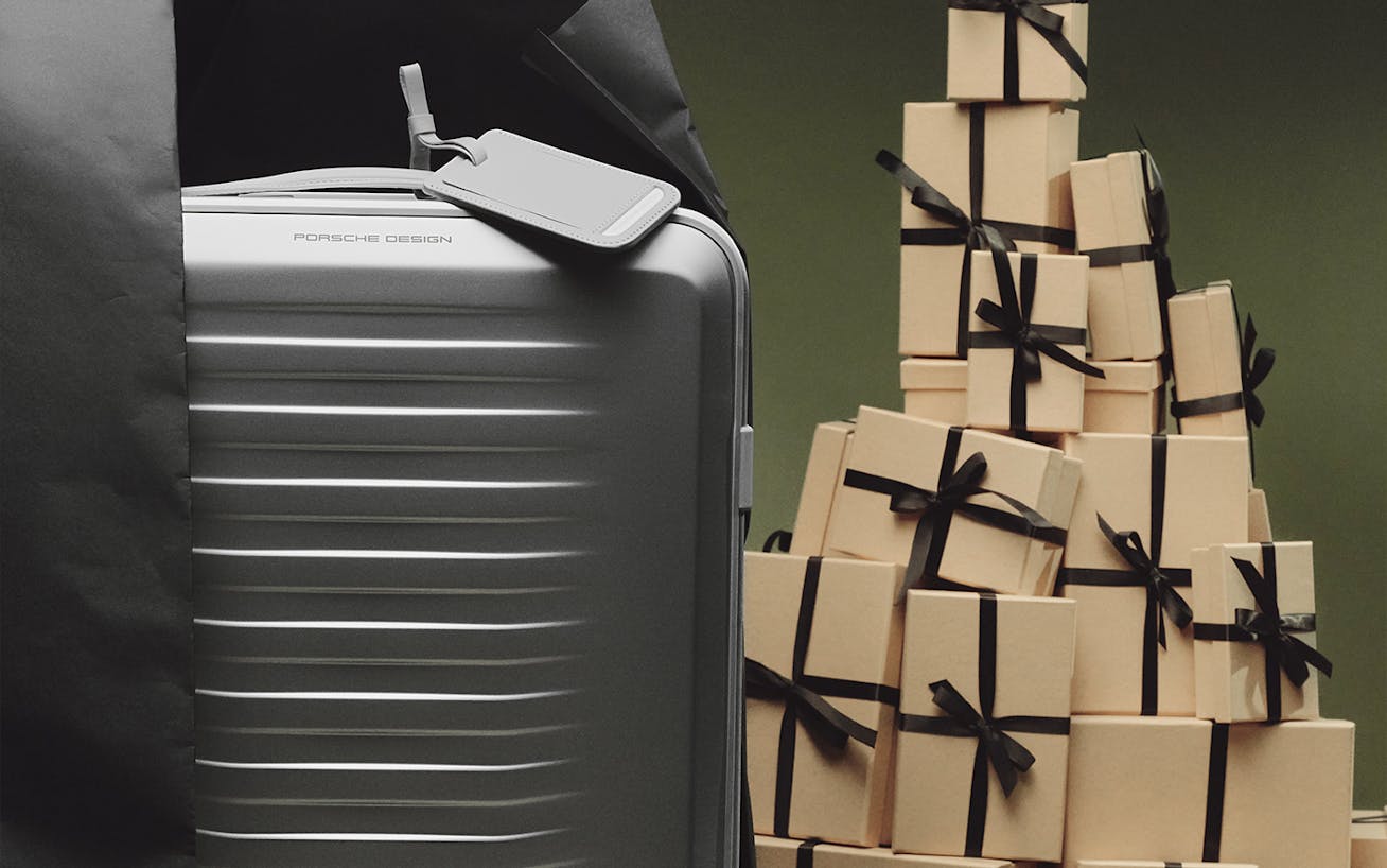 Porsche Design aluminum trolley with gift boxes stacked beside it 