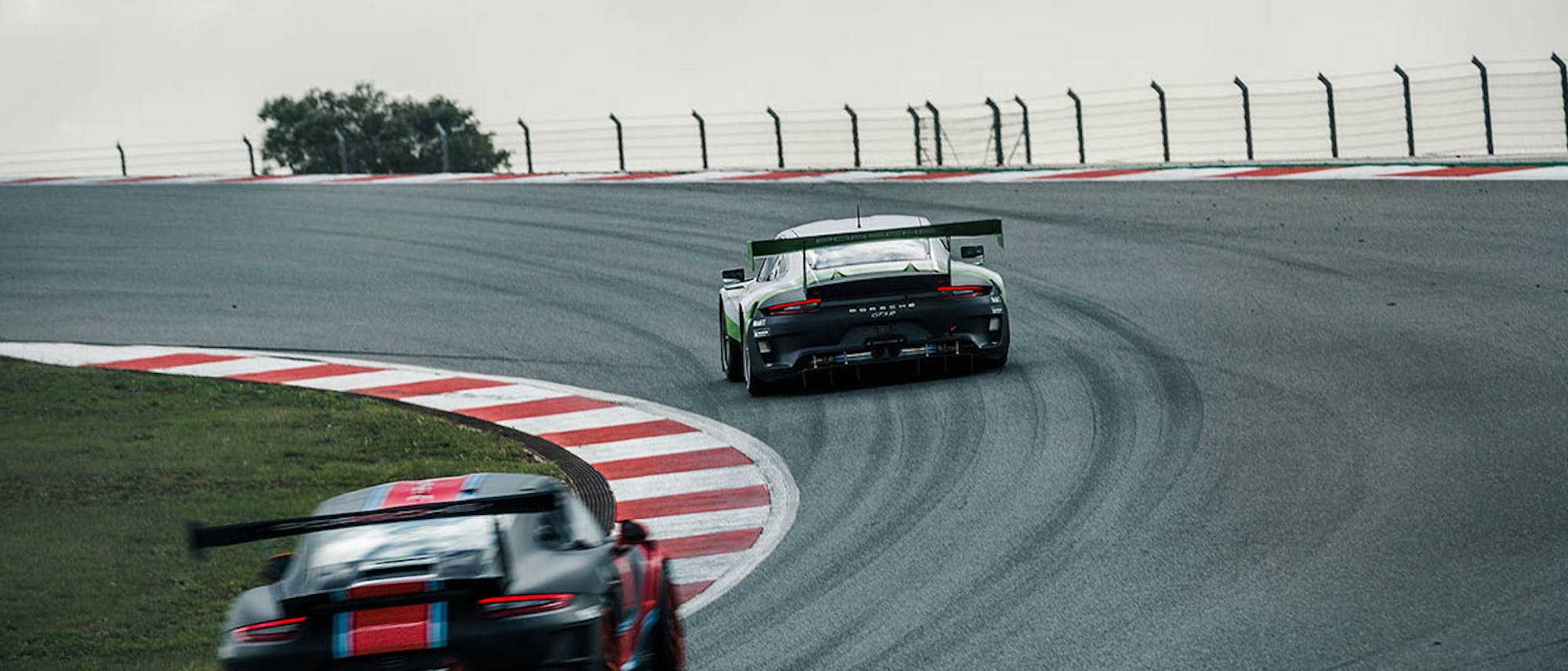 Two Porsche racecars on race track