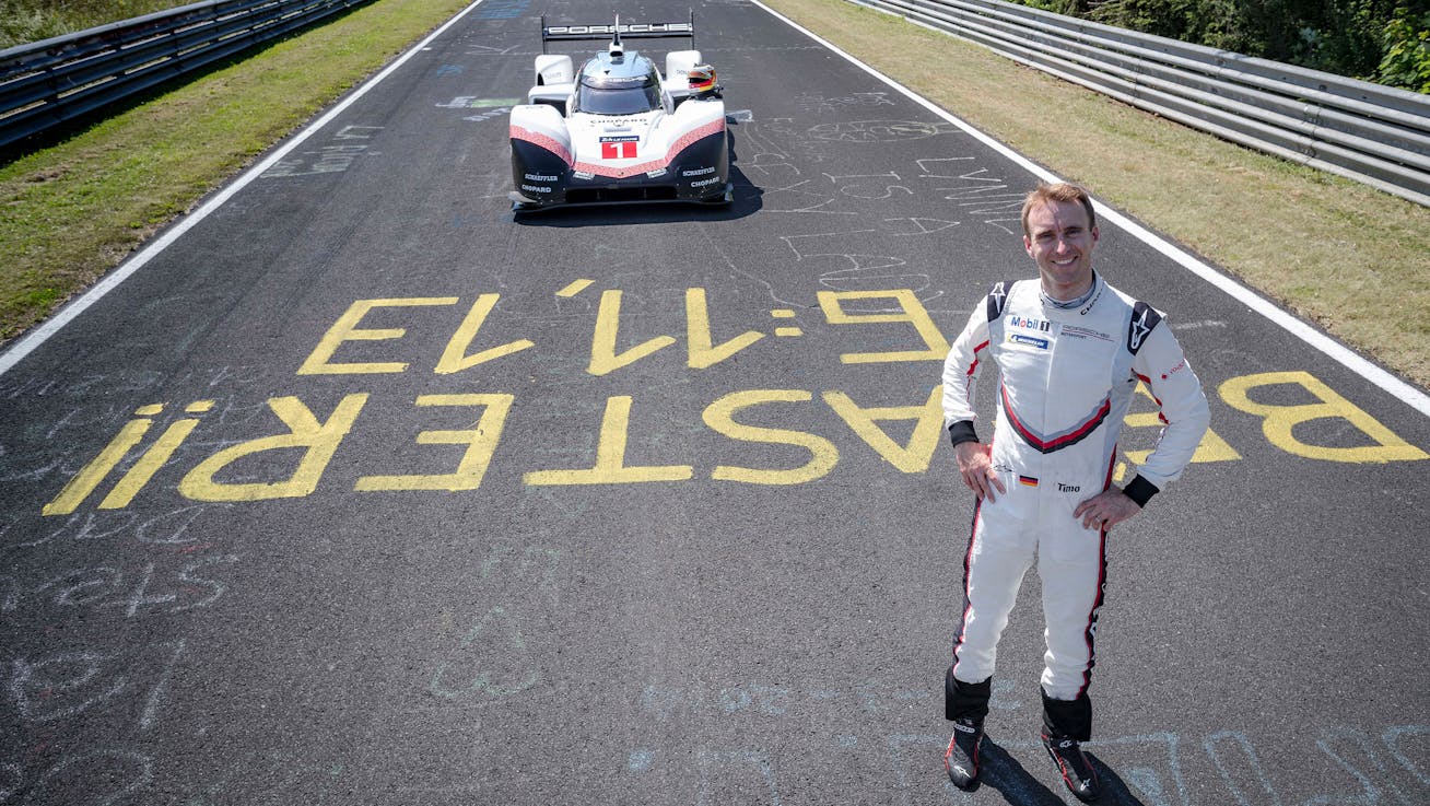 Timo Bernhard in racing suit with Porsche 919 Hybrid Evo in background