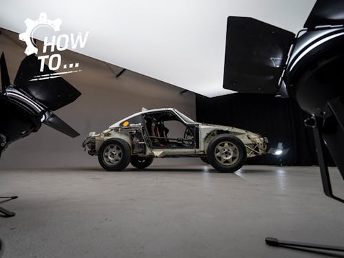 Stripped-down Porsche 959 with doors removed in a photo studio