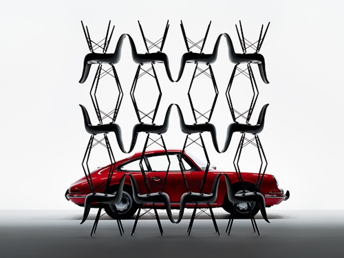 Classic Porsche 911 behind Porsche Pepita Edition by Vitra chairs