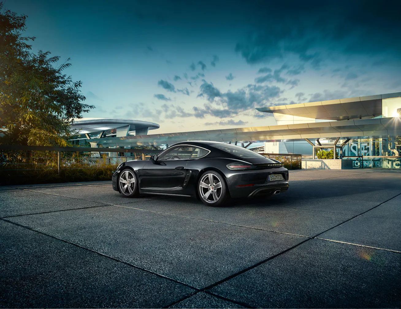 Porsche 718 Cayman parked with futuristic buildings in the background