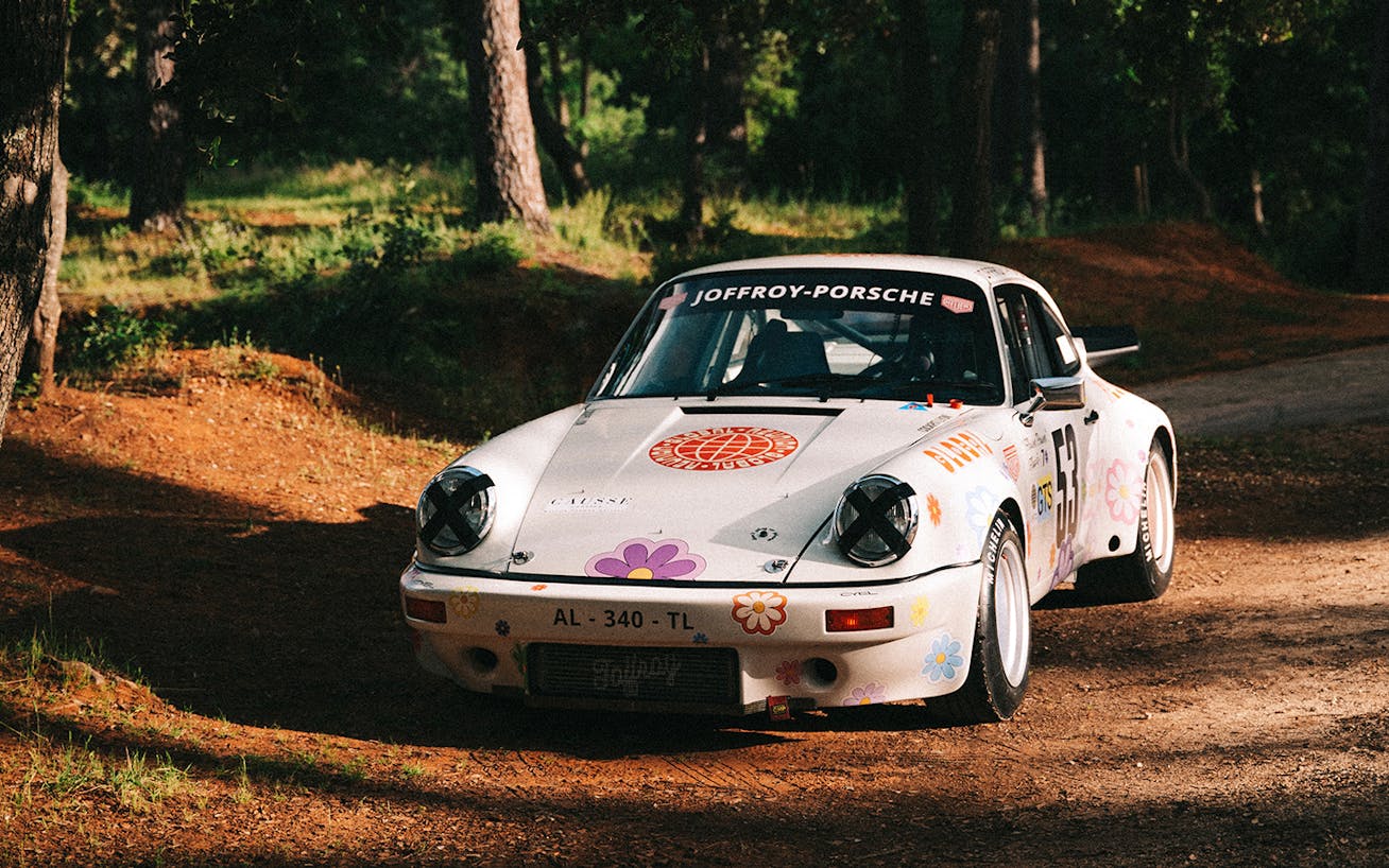 Flower power-themed Porsche 911 3.0 RS in a forest  