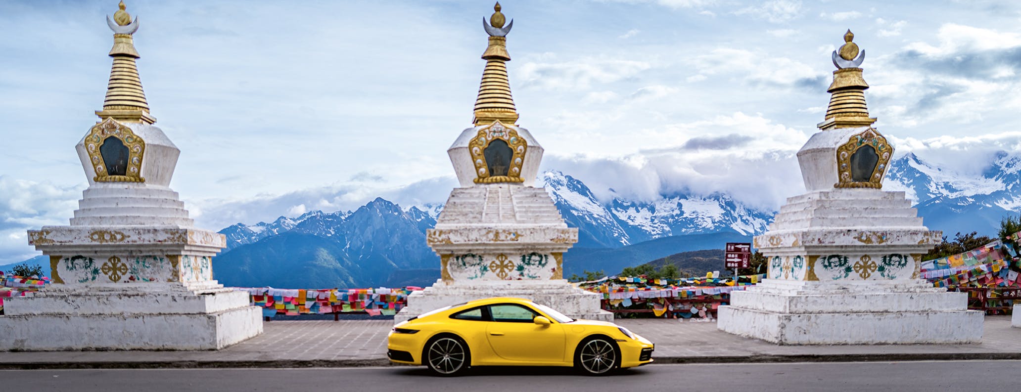 Porsche 911 Carrera against backdrop of mountains in Shangri-La, China 